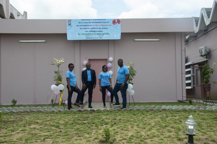 Gima-Bambot team in front of the inauguration banner for the hemodialysis centre extension at Hôpital Général de Douala, October 2021